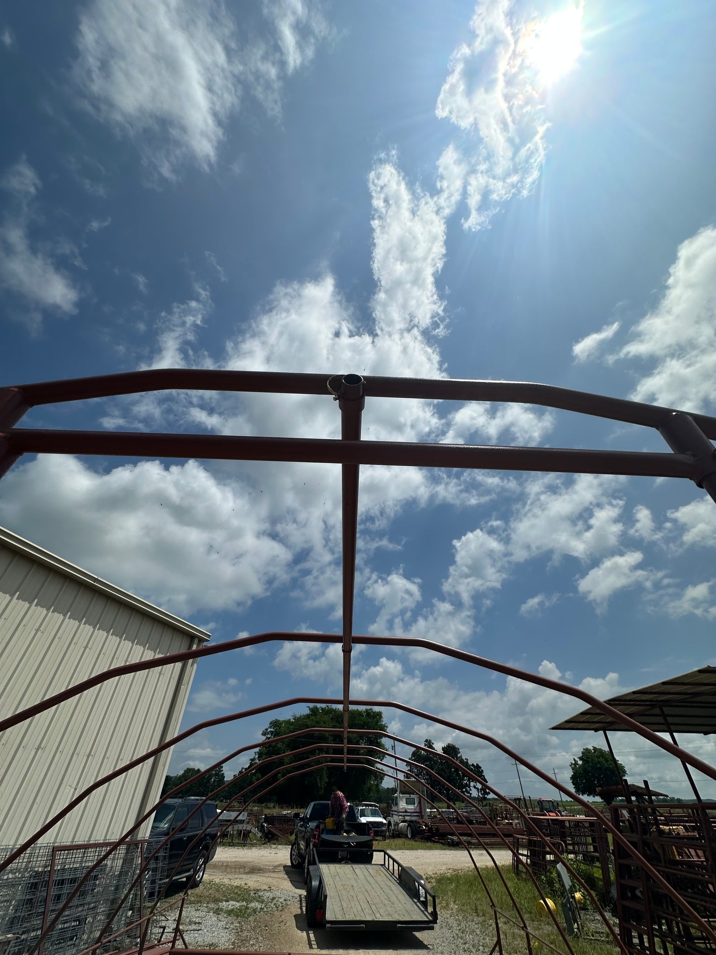 Metal structure with a clear blue sky and clouds in the background