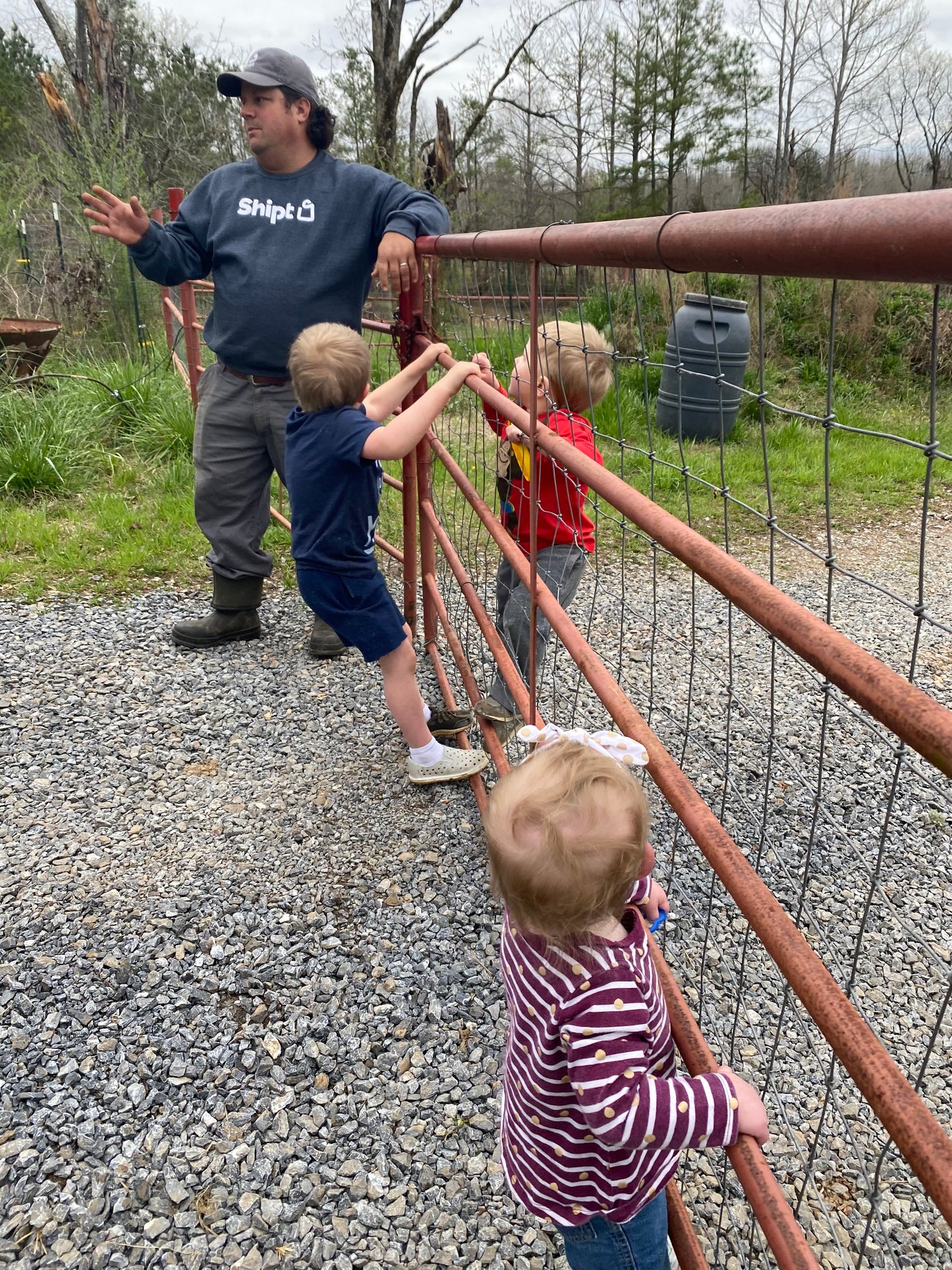 Steel 6-bar gate with 3 children on it